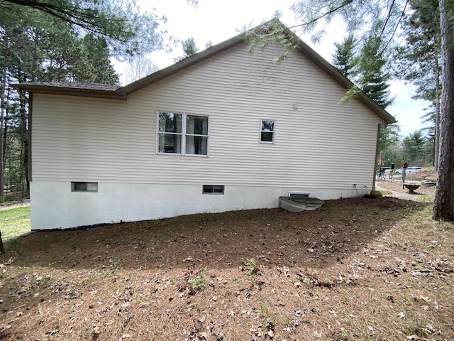 view of side of home featuring crawl space