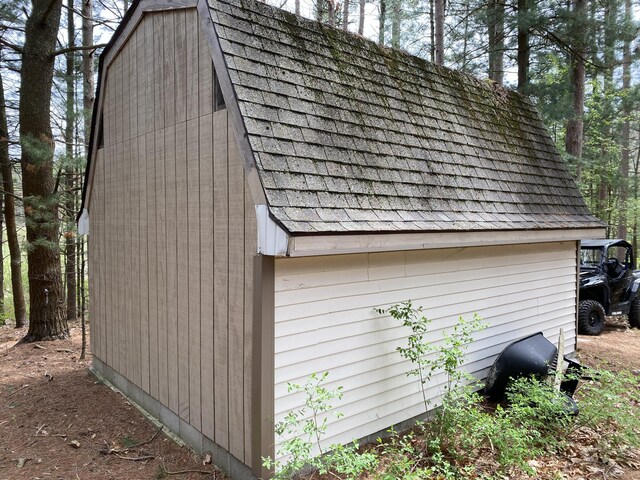view of side of home featuring an outbuilding