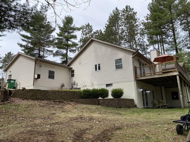 back of house with a deck