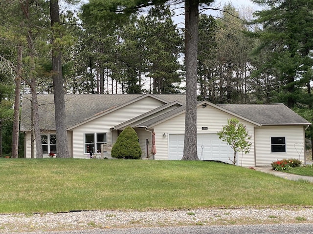 view of home's exterior featuring a garage, a shingled roof, and a yard