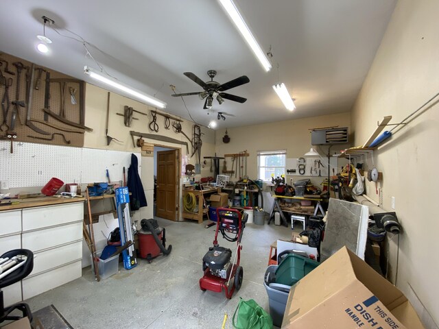 garage featuring a workshop area and ceiling fan