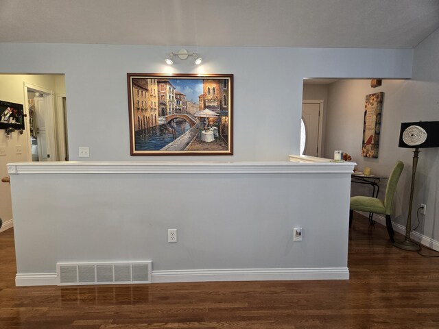 dining room featuring dark wood finished floors and baseboards