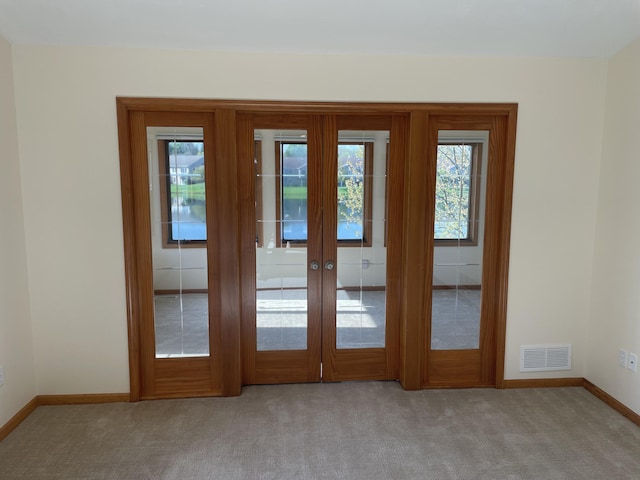 1712 Lisa Dr SW, Byron Center, MI 49315 - entryway with baseboards, light colored carpet, and french doors