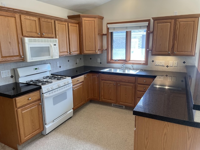 1712 Lisa Dr SW, Byron Center, MI 49315 - kitchen featuring white appliances, a sink, dark countertops, and decorative backsplash