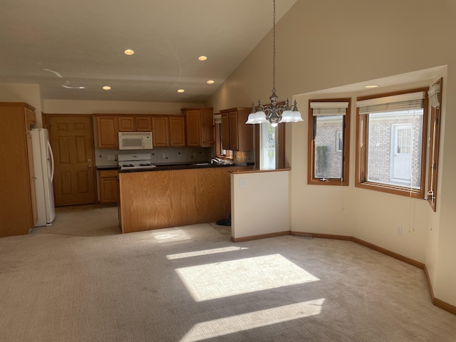 1712 Lisa Dr SW, Byron Center, MI 49315 - kitchen with white appliances, light colored carpet, dark countertops, a peninsula, and a chandelier