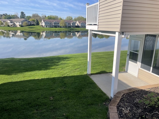 1712 Lisa Dr SW, Byron Center, MI 49315 - view of green lawn featuring a water view, a residential view, and a patio
