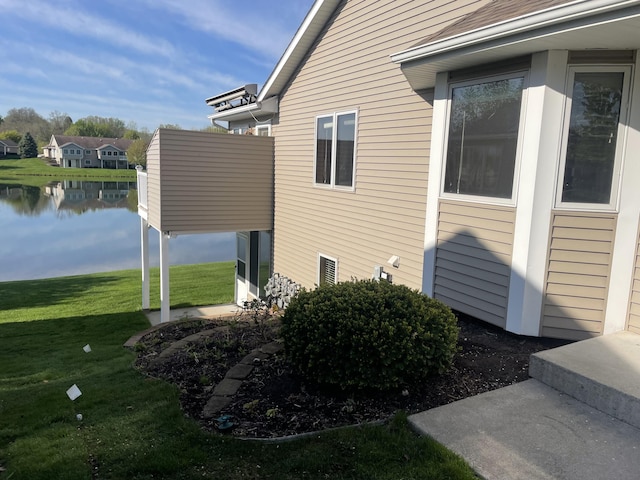 1712 Lisa Dr SW, Byron Center, MI 49315 - view of side of property featuring a lawn and a water view