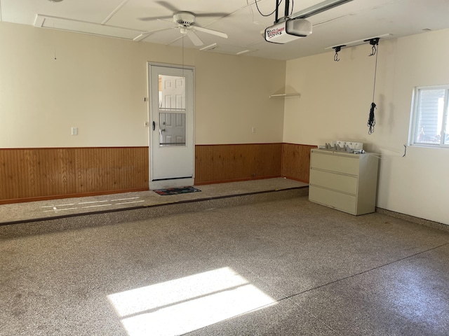 1712 Lisa Dr SW, Byron Center, MI 49315 - garage with wainscoting, a garage door opener, wooden walls, and a ceiling fan