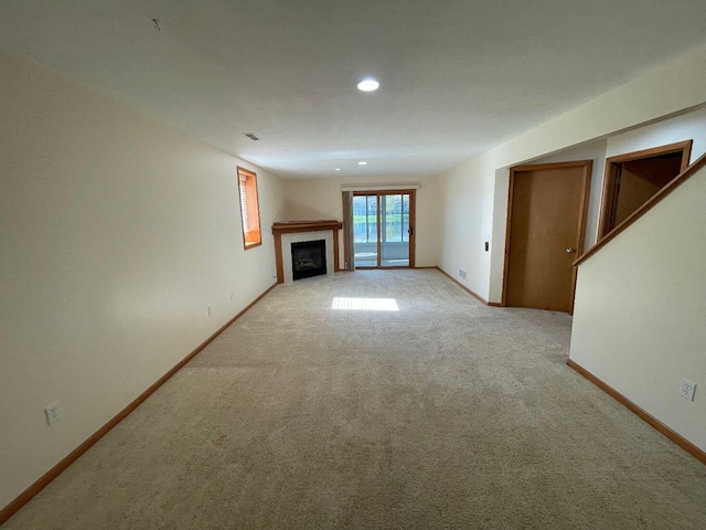 1712 Lisa Dr SW, Byron Center, MI 49315 - unfurnished living room featuring light colored carpet, a tile fireplace, recessed lighting, and baseboards