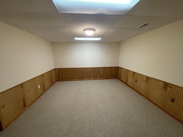 1712 Lisa Dr SW, Byron Center, MI 49315 - finished below grade area featuring a drop ceiling, a wainscoted wall, wooden walls, and light colored carpet