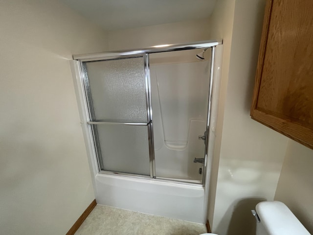 1712 Lisa Dr SW, Byron Center, MI 49315 - full bathroom featuring toilet, combined bath / shower with glass door, and baseboards