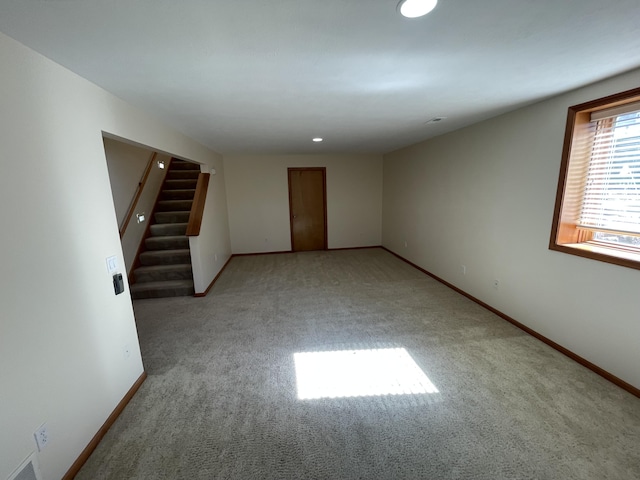 1712 Lisa Dr SW, Byron Center, MI 49315 - unfurnished room with light carpet, stairway, baseboards, and recessed lighting