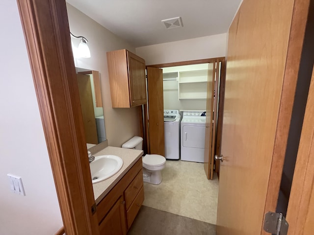 1712 Lisa Dr SW, Byron Center, MI 49315 - half bathroom featuring washer and dryer, vanity, and toilet