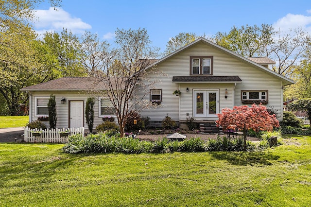 back of house with french doors, a lawn, and a shingled roof