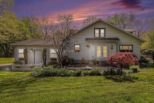 view of front of property featuring french doors and a yard