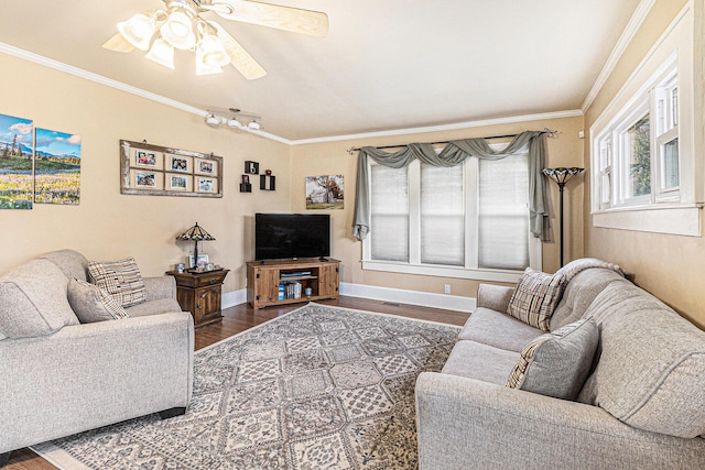living area featuring dark wood finished floors, ornamental molding, a ceiling fan, and baseboards