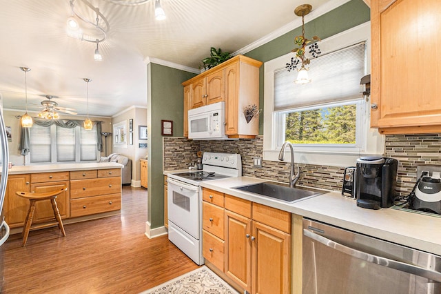 kitchen with white appliances, a sink, ornamental molding, tasteful backsplash, and light countertops