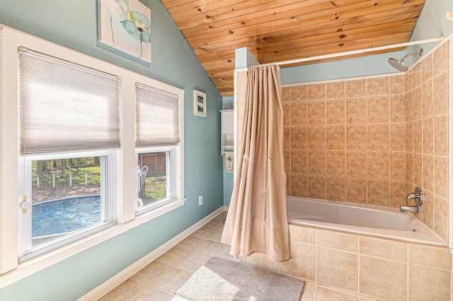 bathroom featuring wood ceiling, vaulted ceiling, tile patterned floors, tiled shower / bath, and baseboards