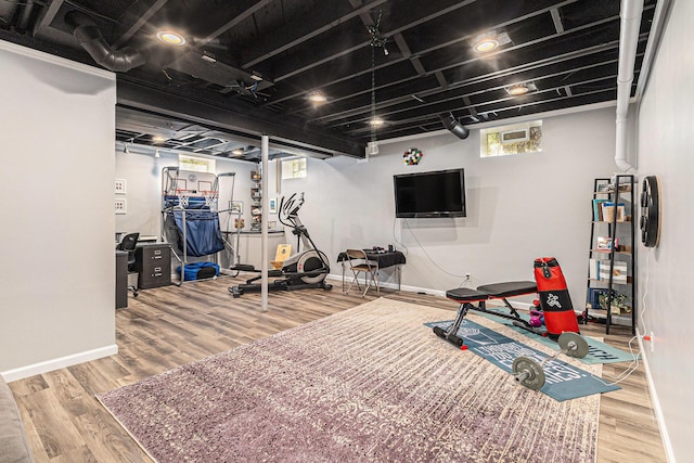 workout area with wood finished floors and baseboards