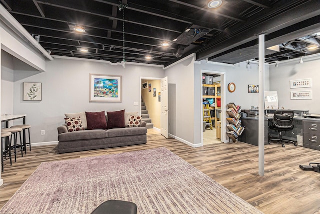 living room with baseboards, wood finished floors, an office area, and stairs