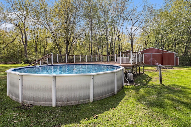 outdoor pool featuring a yard, a deck, and view of wooded area