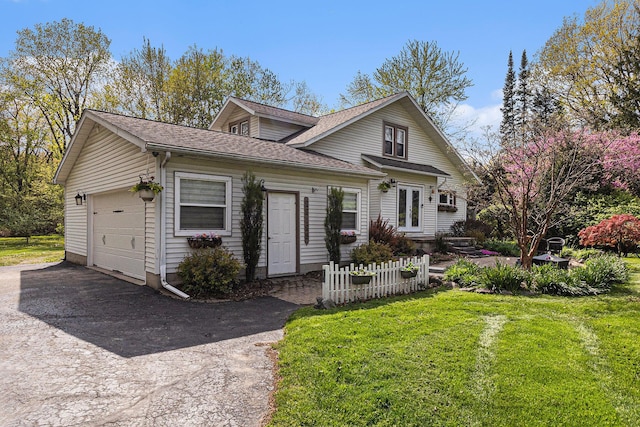 view of front of home featuring driveway, a garage, a shingled roof, and a front lawn