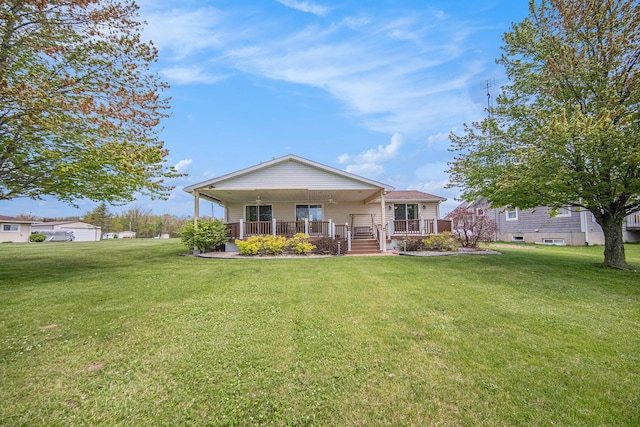 14682 E Merry Dr, Camden, MI 49232 - rear view of house with covered porch and a lawn