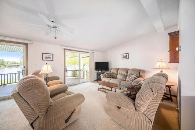 14682 E Merry Dr, Camden, MI 49232 - living room with light carpet, lofted ceiling, ceiling fan, and a water view