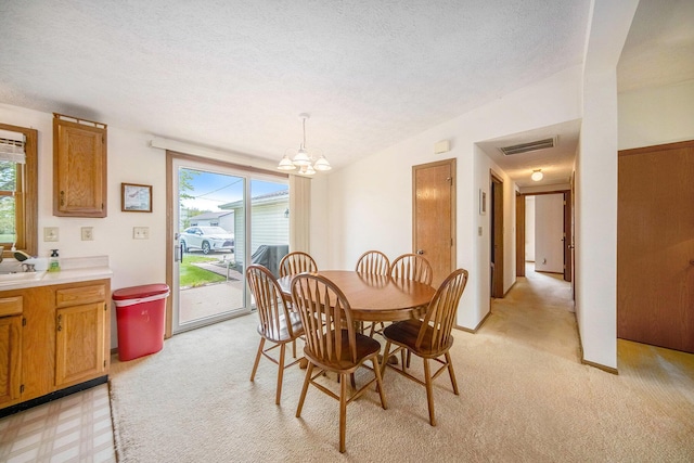 14682 E Merry Dr, Camden, MI 49232 - dining area featuring a chandelier, a textured ceiling, and light colored carpet