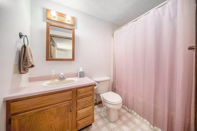 14682 E Merry Dr, Camden, MI 49232 - full bathroom with toilet, tile patterned floors, a textured ceiling, and vanity