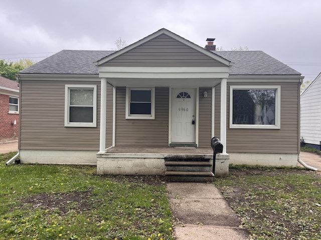 9960 Tecumseh, Redford, MI 48239 - bungalow featuring roof with shingles, a chimney, and covered porch