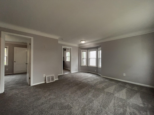 9960 Tecumseh, Redford, MI 48239 - spare room with crown molding, baseboards, and dark carpet