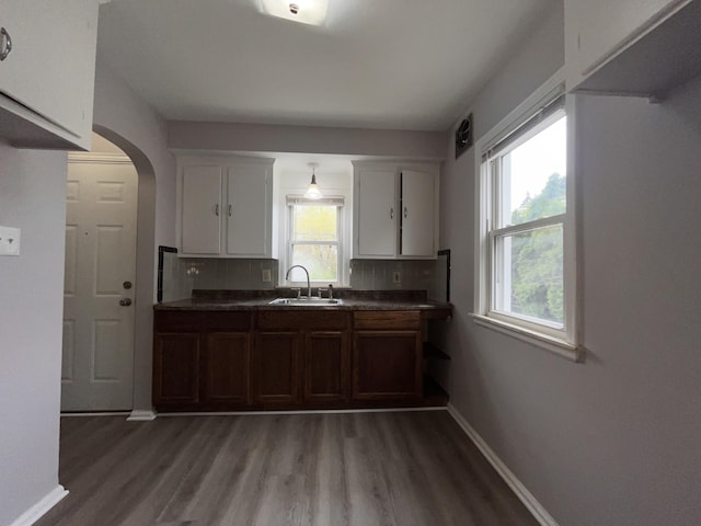 9960 Tecumseh, Redford, MI 48239 - kitchen with a sink, arched walkways, light wood-style flooring, and tasteful backsplash