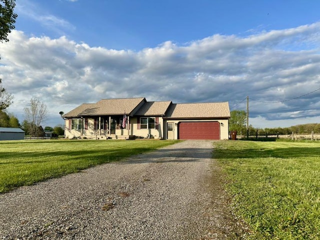 single story home featuring driveway, an attached garage, and a front yard