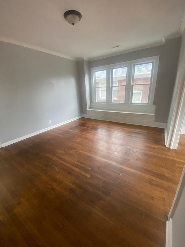 2135 Lakewood St, Detroit, MI 48215 - empty room featuring dark wood-style floors, baseboards, and crown molding