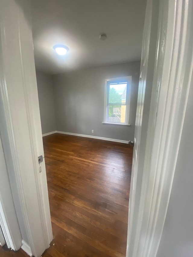 2135 Lakewood St, Detroit, MI 48215 - unfurnished room with dark wood finished floors, baseboards, and a smoke detector