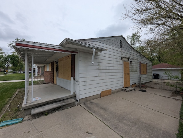 view of property exterior with a patio area and fence