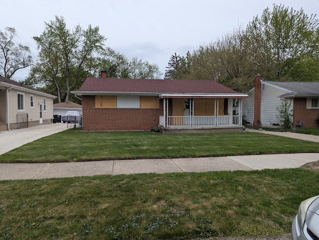 ranch-style house with covered porch, brick siding, a front yard, and a chimney