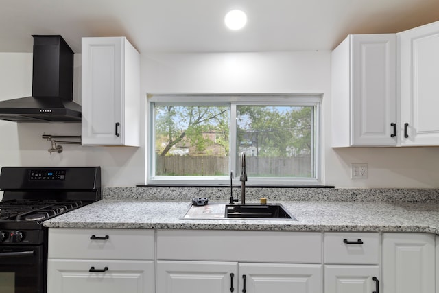 19178 Sherwood St, Detroit, MI 48234 - kitchen with black gas stove, wall chimney exhaust hood, a sink, and white cabinetry