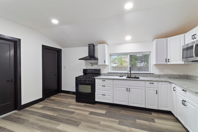 19178 Sherwood St, Detroit, MI 48234 - kitchen featuring black gas range, wall chimney exhaust hood, a sink, stainless steel microwave, and vaulted ceiling