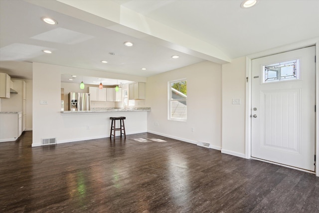 25034 Redfield St, Edwardsburg, MI 49112 - unfurnished living room featuring dark wood-type flooring, recessed lighting, and baseboards