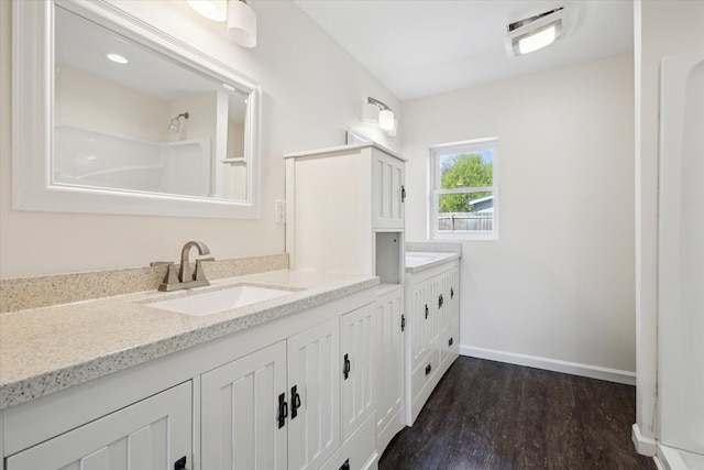 25034 Redfield St, Edwardsburg, MI 49112 - full bathroom with vanity, wood finished floors, baseboards, and a shower