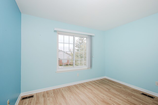 empty room with wood finished floors and baseboards