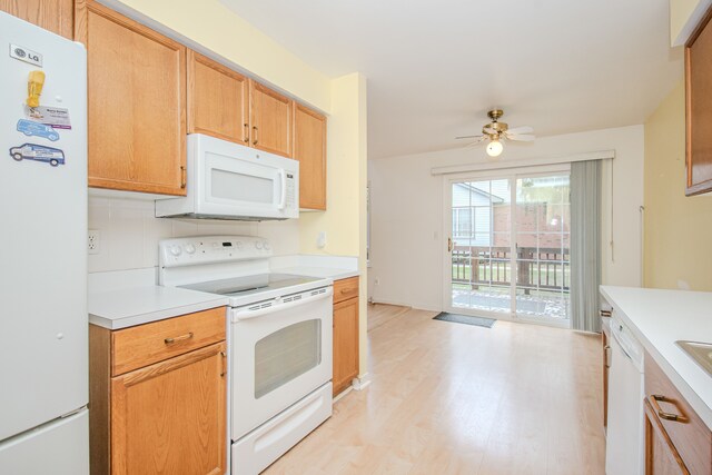 kitchen with white appliances, light countertops, light wood-style floors, a ceiling fan, and tasteful backsplash