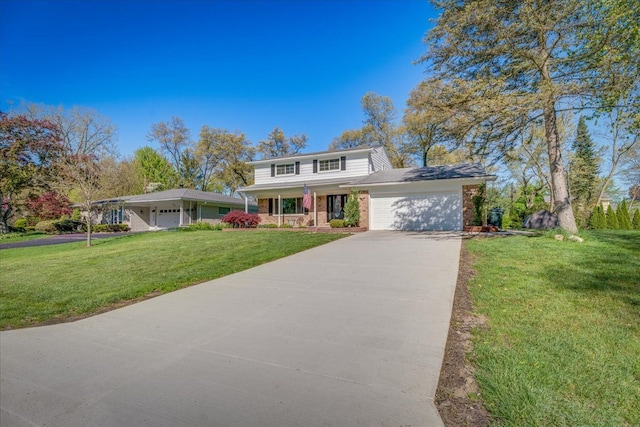 traditional home with an attached garage, driveway, a front lawn, brick siding, and covered porch
