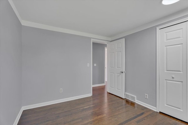 unfurnished bedroom featuring dark wood-style flooring and baseboards