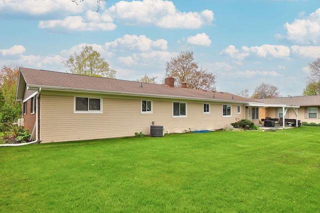 932 E Genesee St, Frankenmuth, MI 48734 - back of house with a patio area, a yard, a chimney, and cooling unit