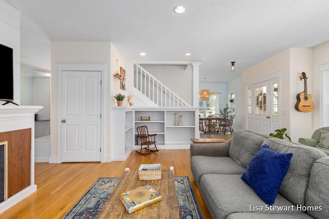 2445 Honey Creek Ave NE, Ada, MI 49301 - living room featuring wood finished floors, stairs, and recessed lighting