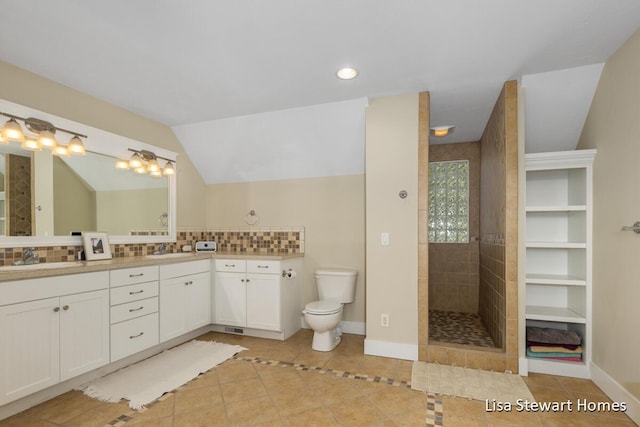 2445 Honey Creek Ave NE, Ada, MI 49301 - full bathroom featuring tile patterned flooring, double vanity, tasteful backsplash, toilet, and tiled shower