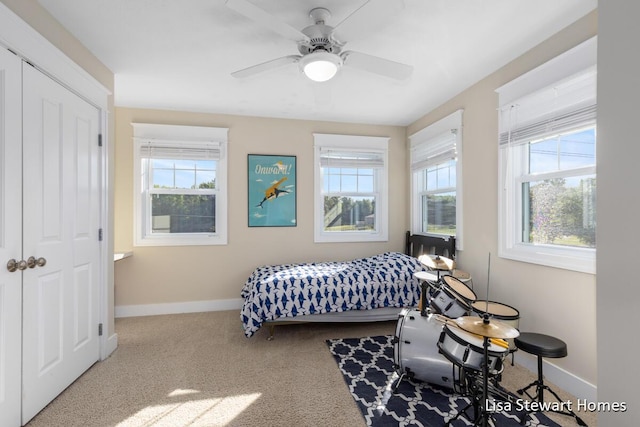 2445 Honey Creek Ave NE, Ada, MI 49301 - carpeted bedroom featuring multiple windows, baseboards, and a ceiling fan